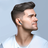 Man wearing a wireless earbud with a gray background