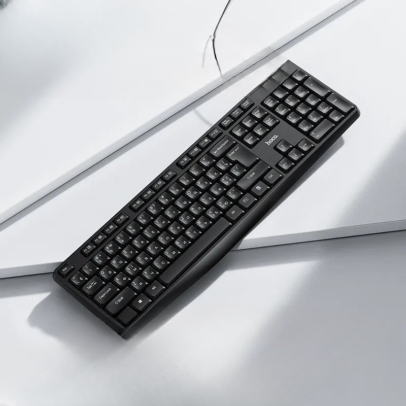 Black keyboard on a light gray surface with a white background