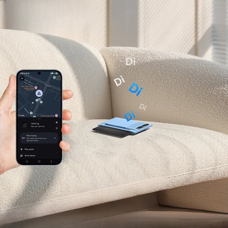 Hand holding a smartphone with a map app on a beige sofa