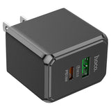 Black power adapter with dual USB ports on a white background