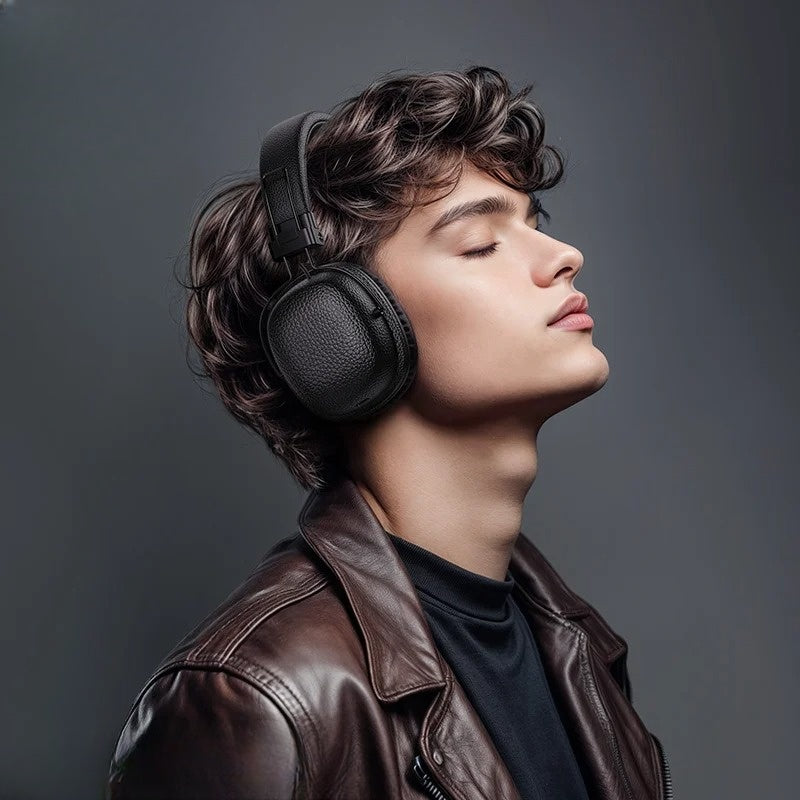 Person wearing black headphones and a brown leather jacket against a gray background
