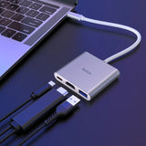 Hoco USB hub connected to a laptop on a dark blue background