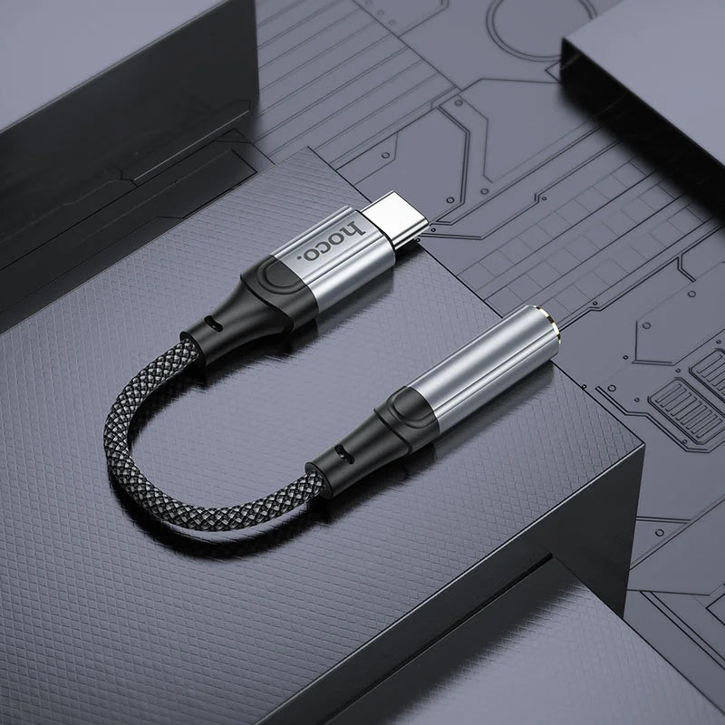 Braided USB cable with connectors on a technical design background