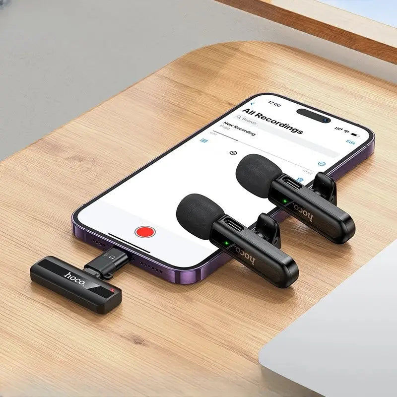 Hoco microphone setup with smartphone displaying recording app on a wooden surface